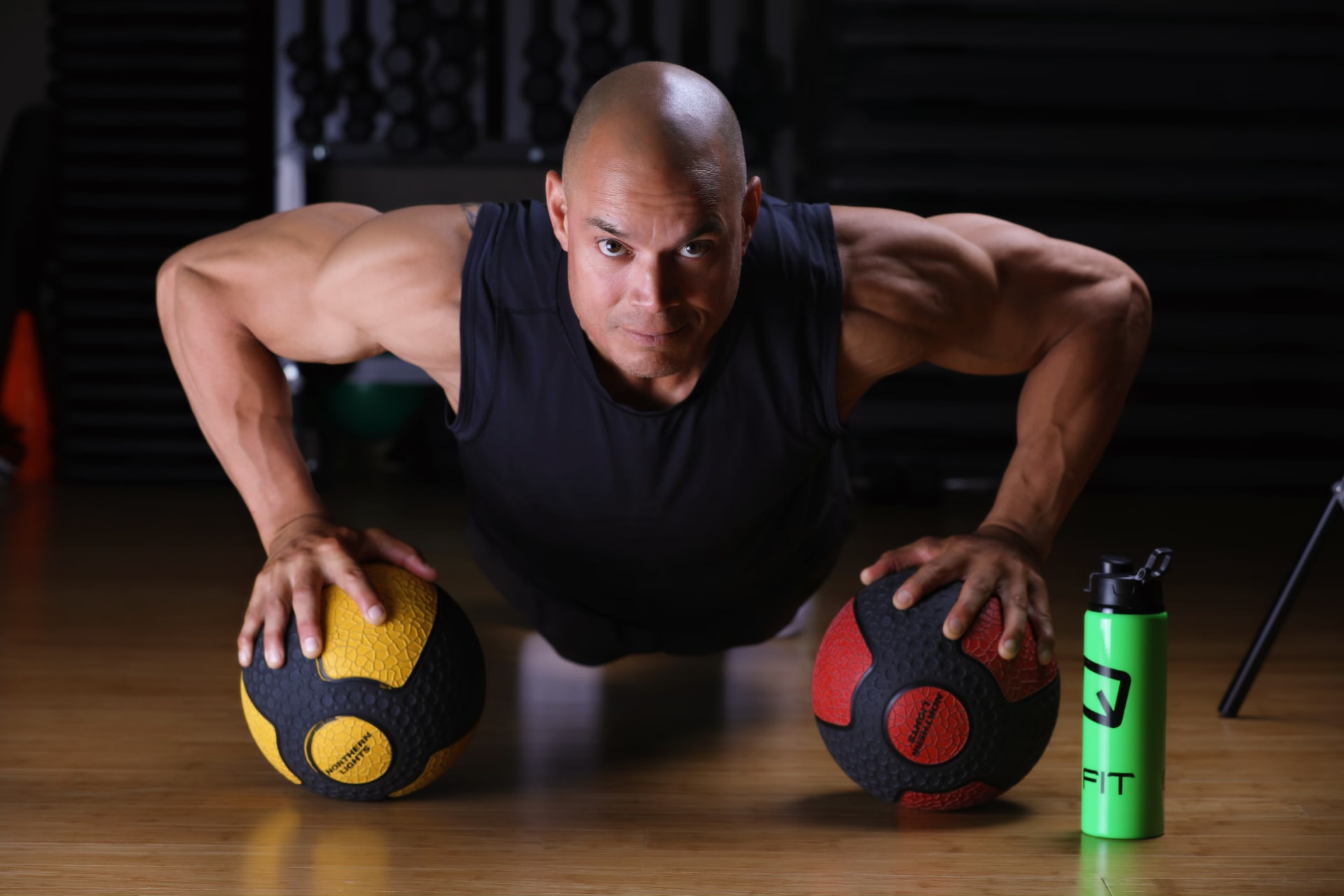 Athlete doing medicine-ball push-ups at QuadFit Club