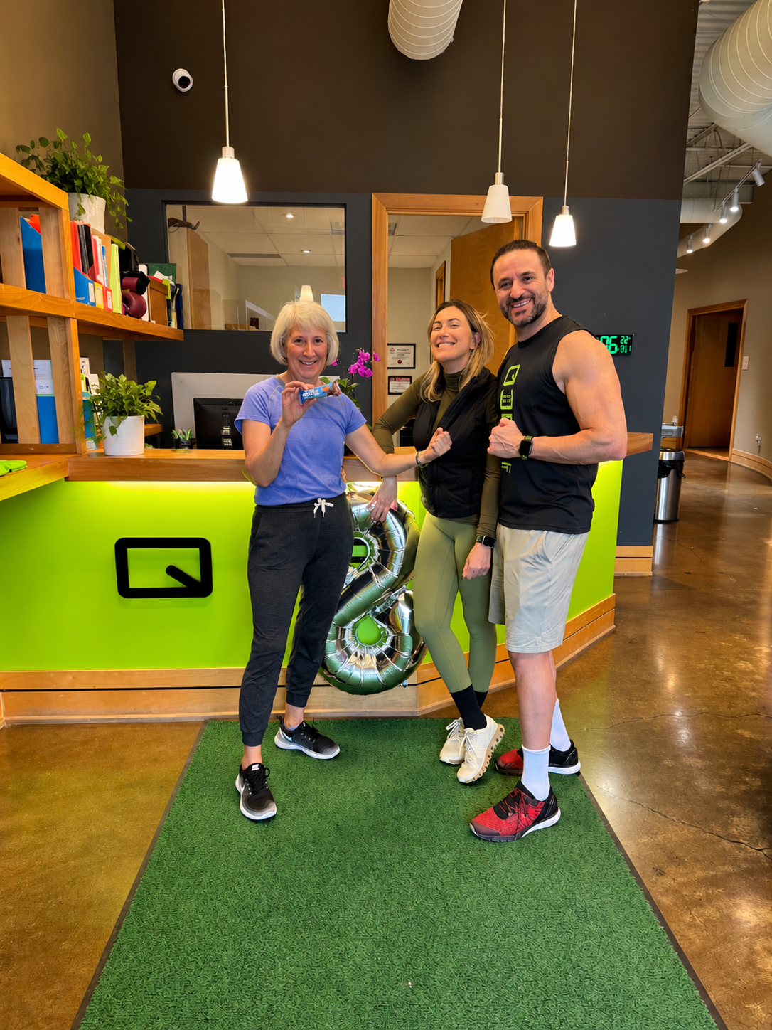 Two senior women smiling together at the gym